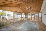 802 E Oak Island Drive, Oak Island, NC 28465 — 3-bedroom home in Long Beach, Oak Island, NC, photo 7 of 27: Screenedin Porch-025-022-1500x1000
